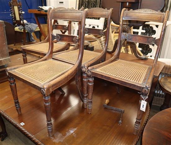 A set of four simulated rosewood beech cane seat dining chairs